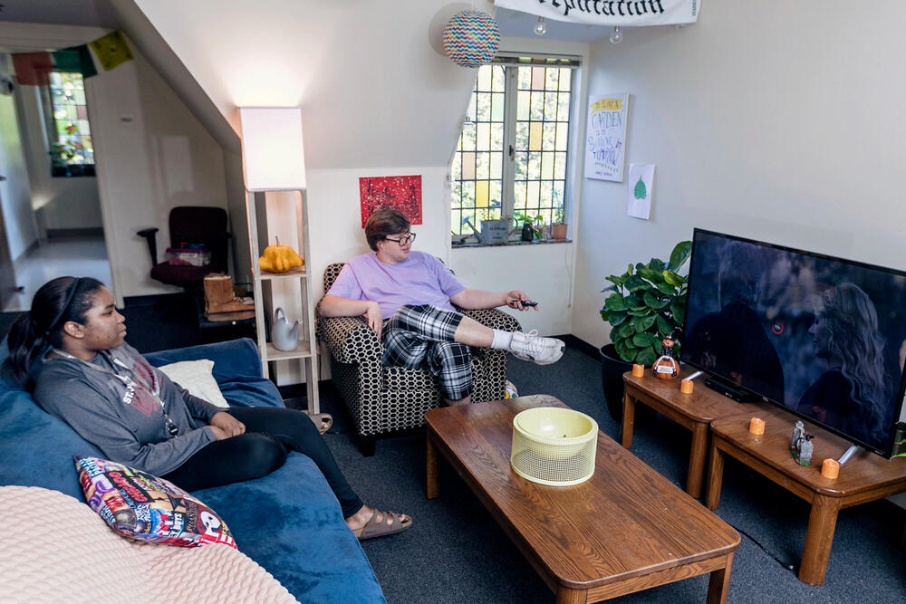 students watch tv in a dorm room