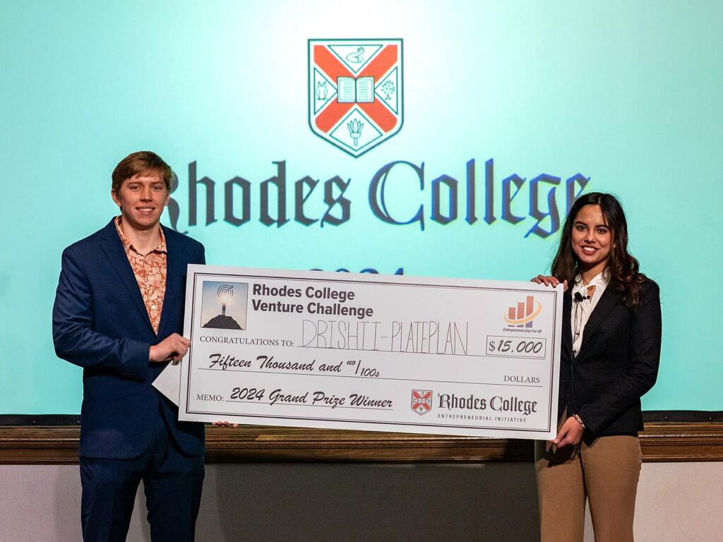 image of two Rhodes College students holding giant check