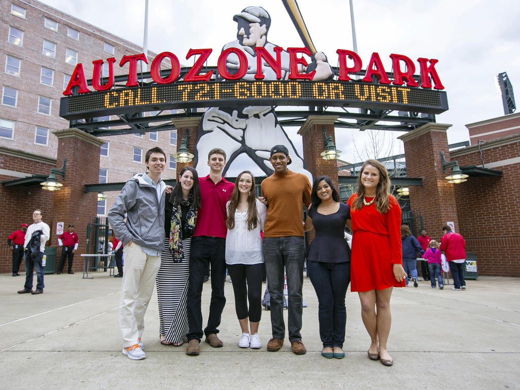 a diverse group of students standing outside of Autozone Park