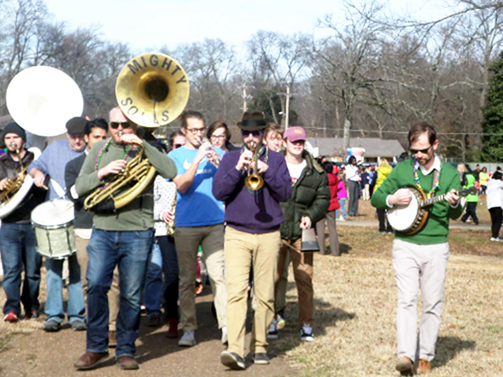 a diverse group of students marching with their band instruments