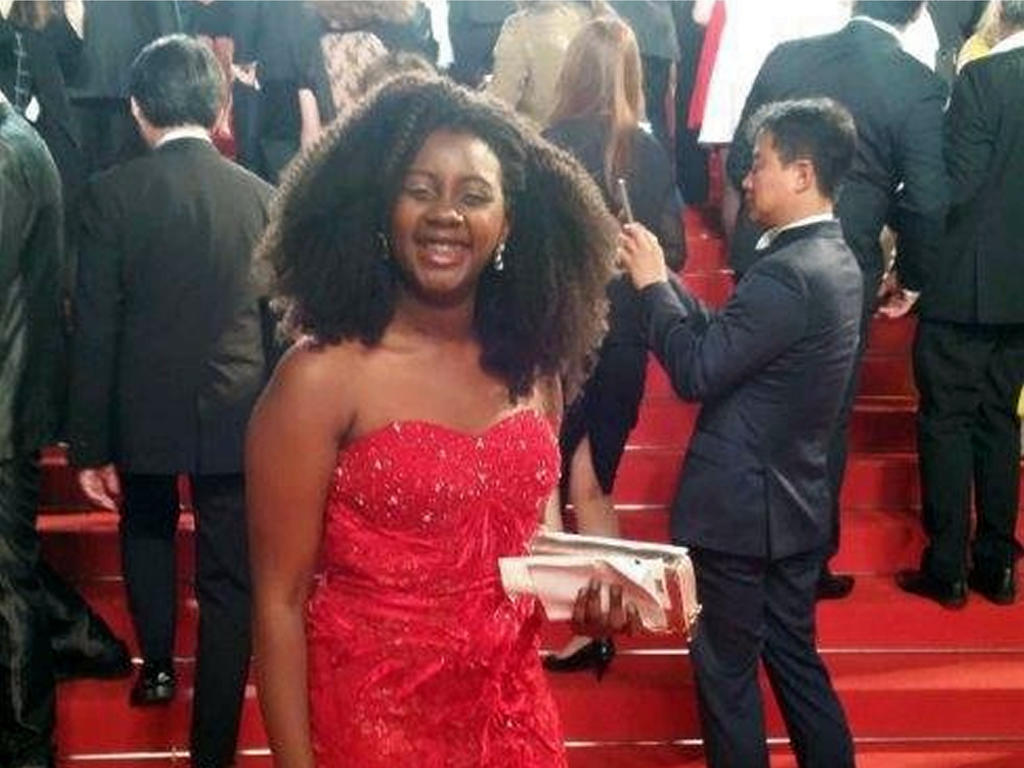 a young woman on the red carpet of a movie premiere 