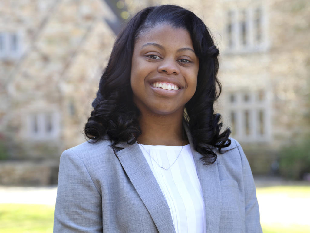 a young african american female student in professional attire and smiling