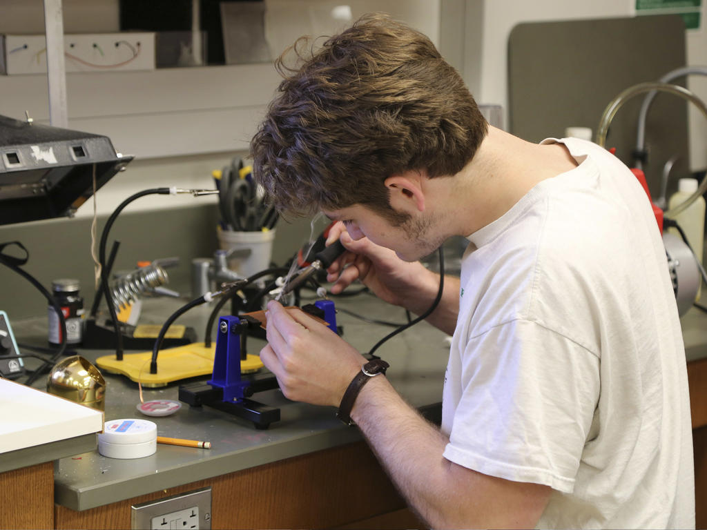 A student soldering a circuit