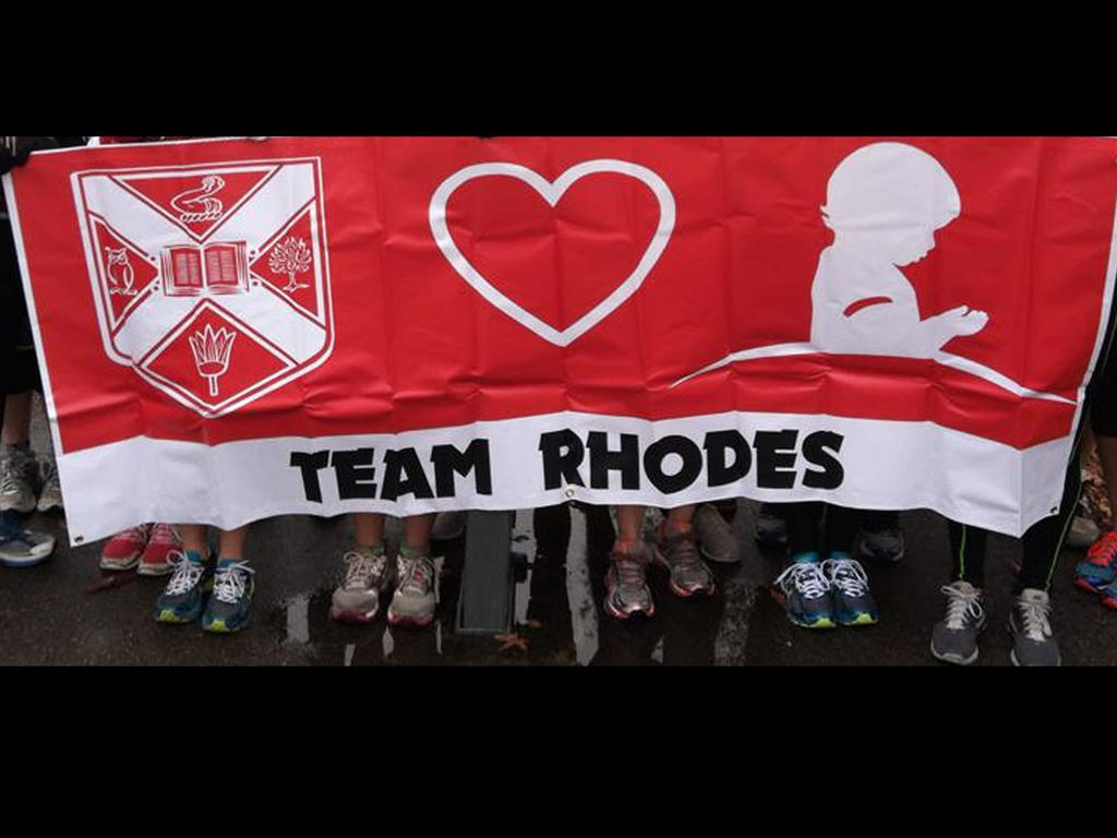 a banner that has the Rhodes crest and the St. Jude logo that says "Team Rhodes"