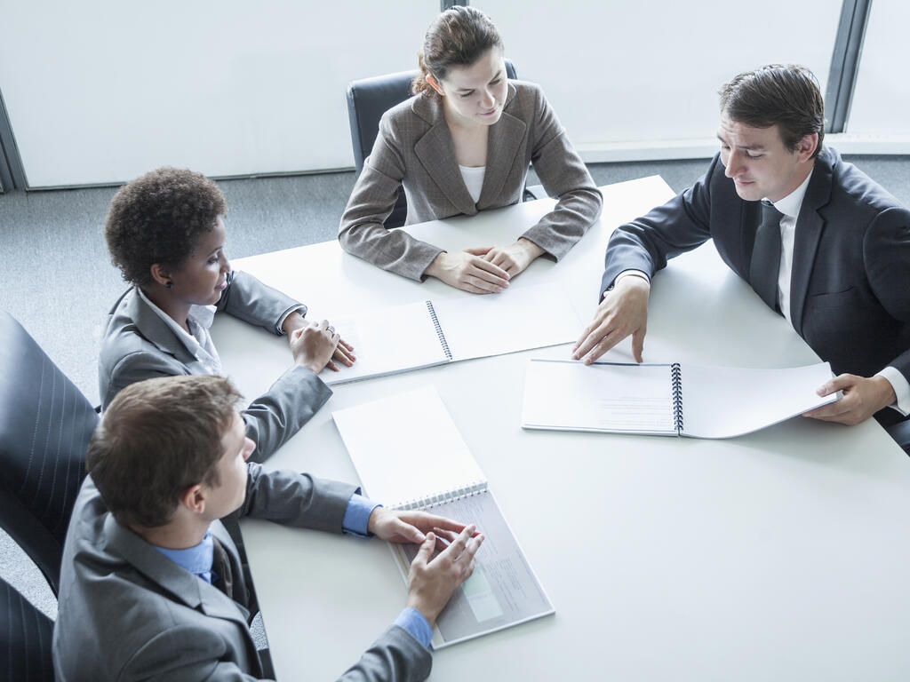 a stock image of a board meeting in a sleek, modern room