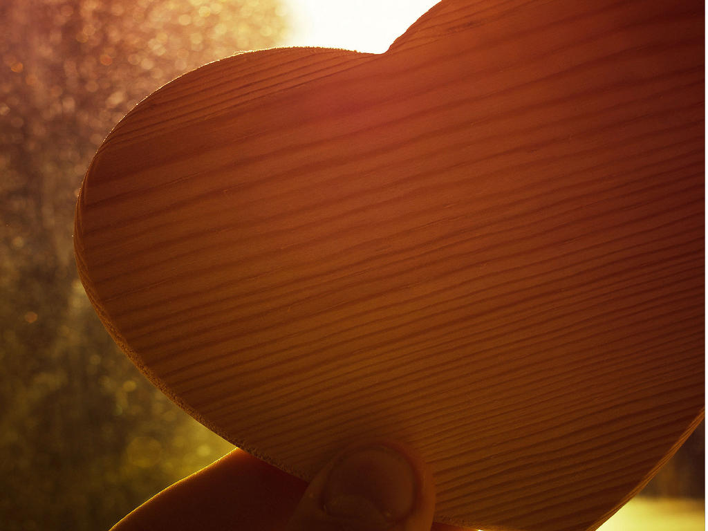 a cut out of a heart with the sun lighting the back of the picture