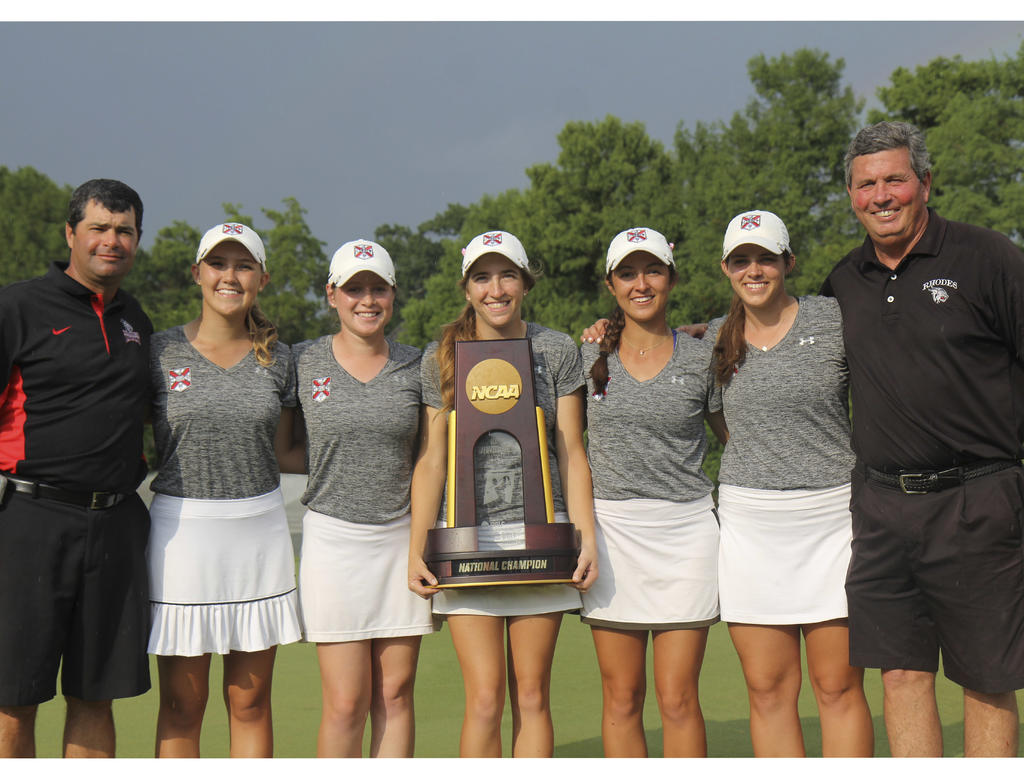 the women's golf team with their coaches proudly holding their trophy