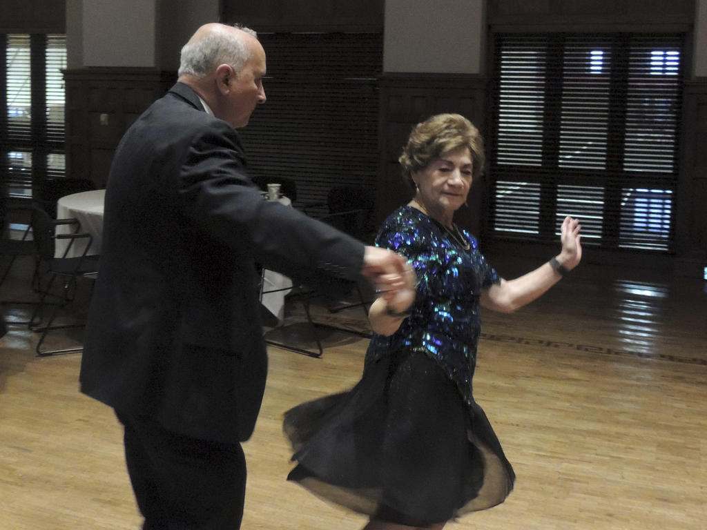 a senior citizen couple dancing vivaciously at the prom at Rhodes College