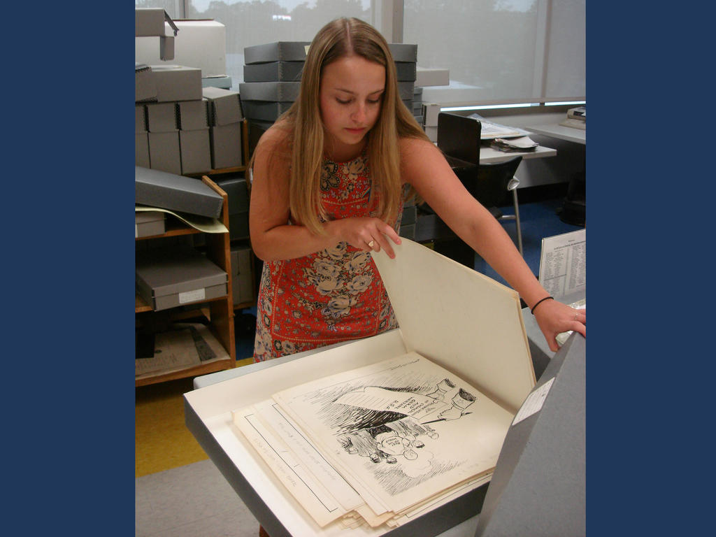 a young female student studying a large book