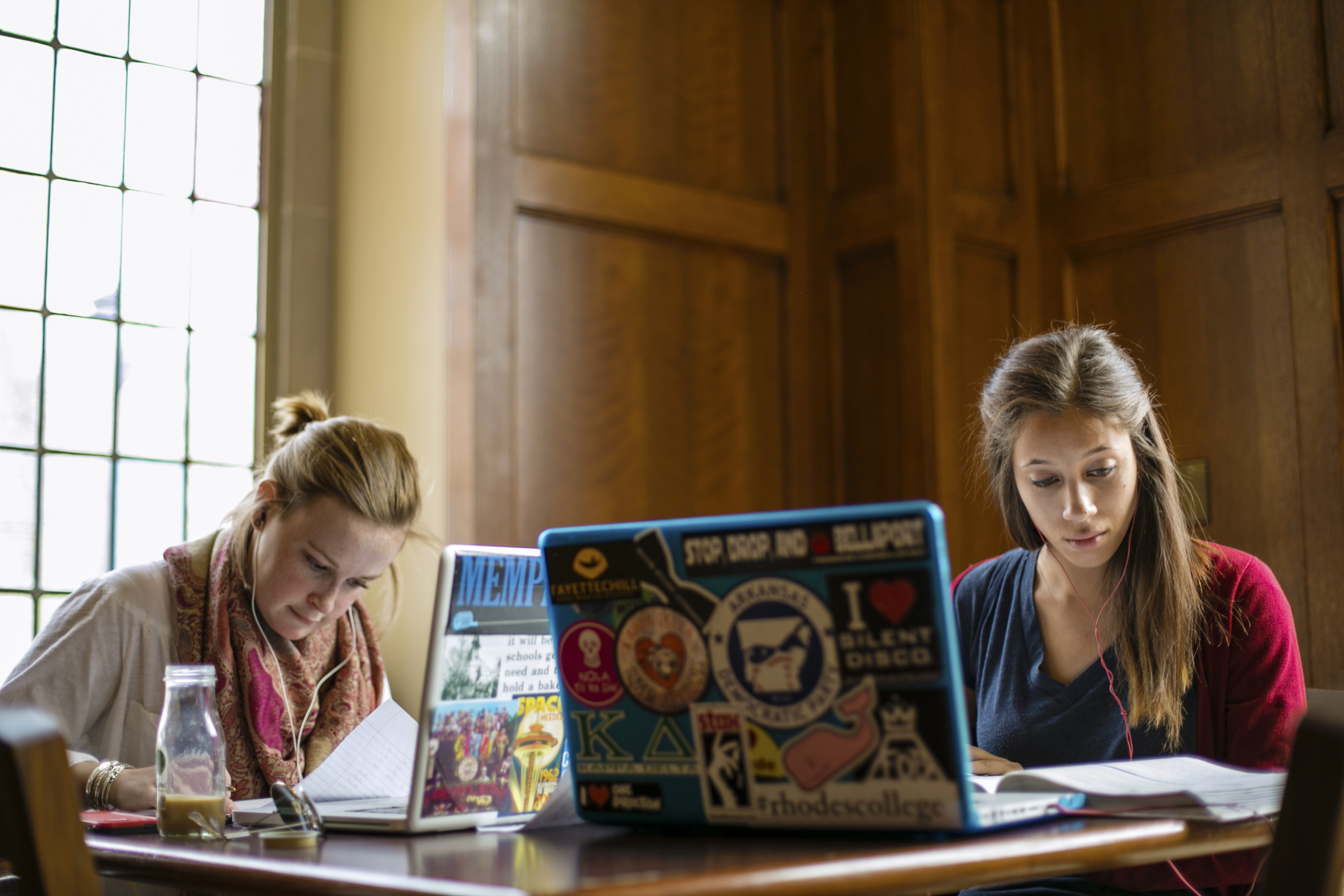 Two students studying with a laptop