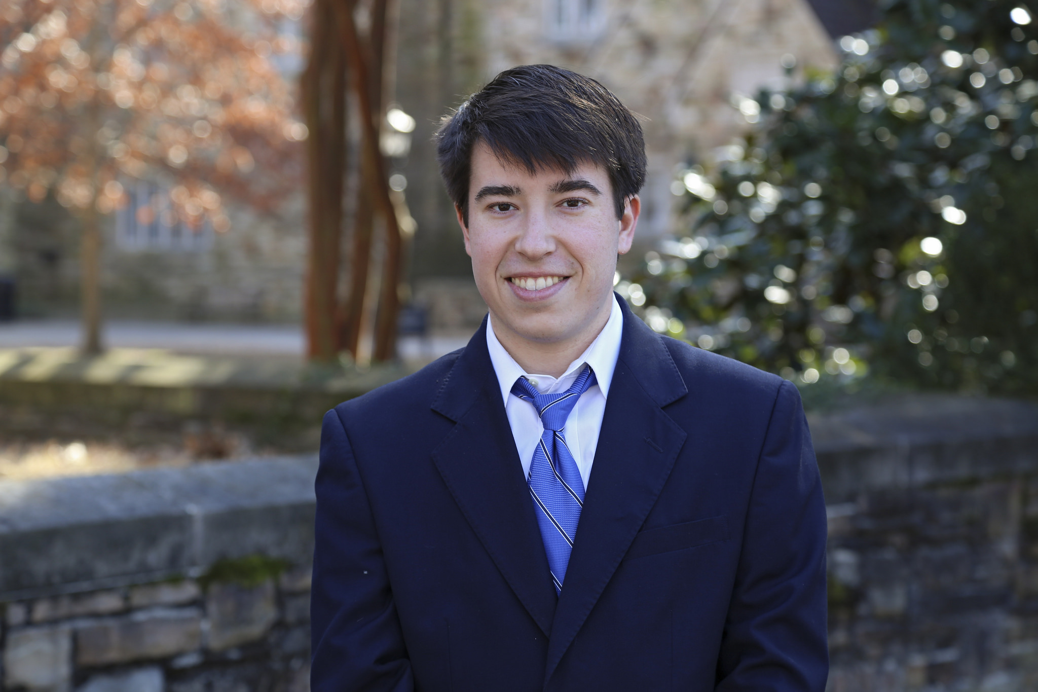 Portrait of Ben Tracy outside by a tree