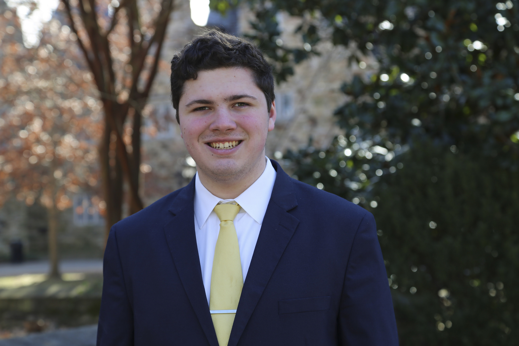 Portrait of Alex Schramkowski outside by a tree