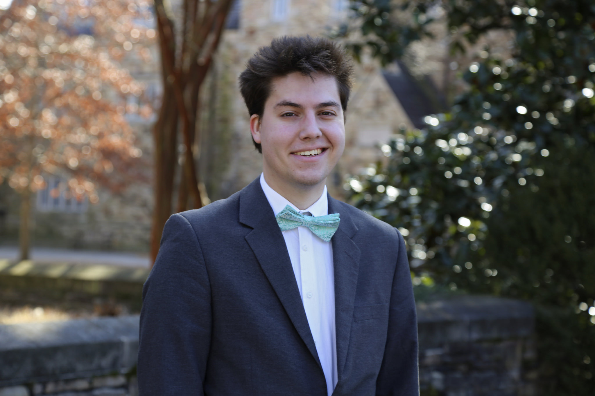 Portrait of Austin Schmude by a tree