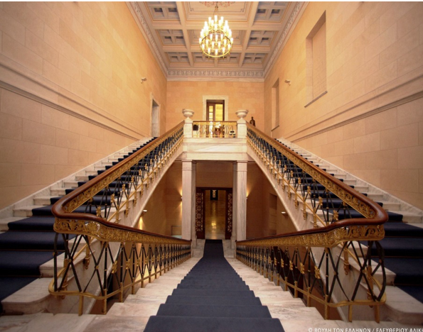A photo of a hall with two staircases going up each side