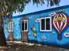 A mostly blue mural featuring a hot air balloon
