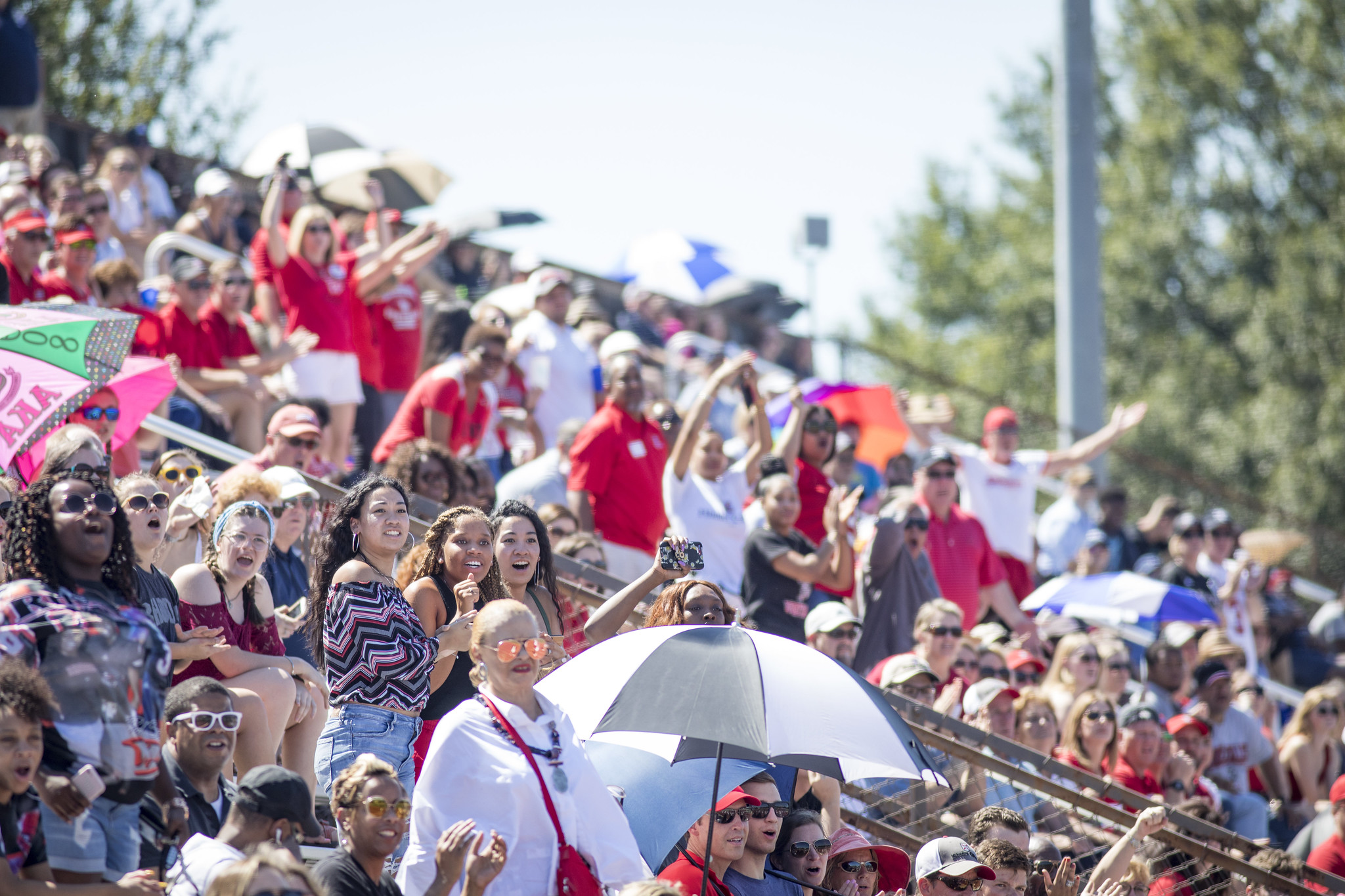 people attending a football game on campus
