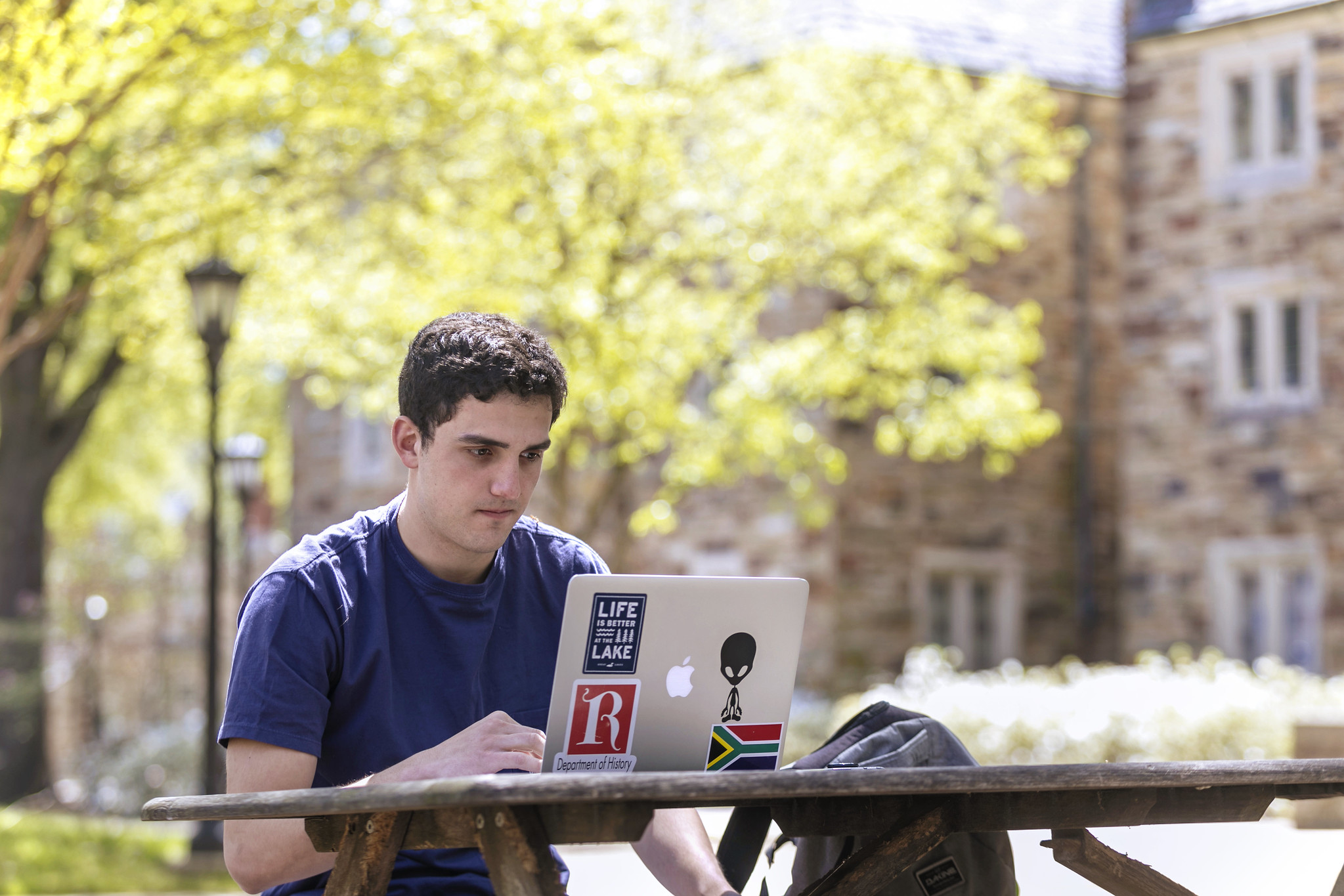 a male student looking at a laptop