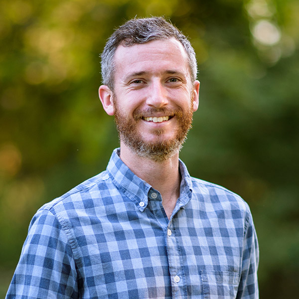head shot of male with a short beard and plaid shirt