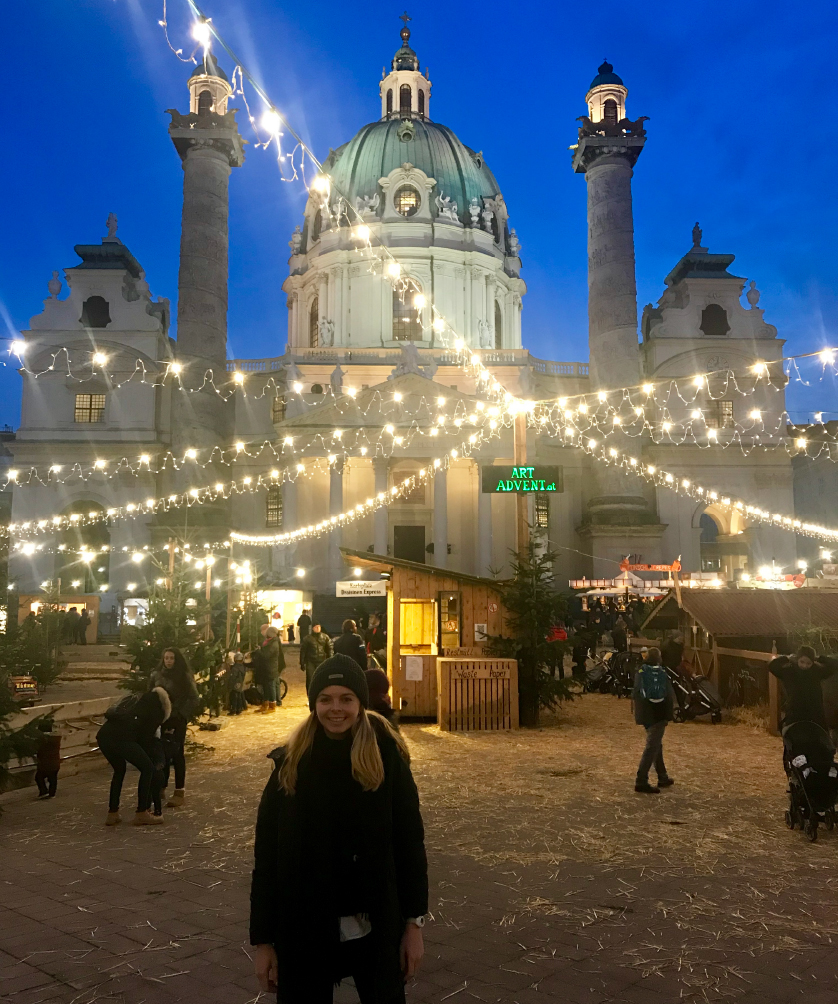 a young woman stands in a plaza in Vienna