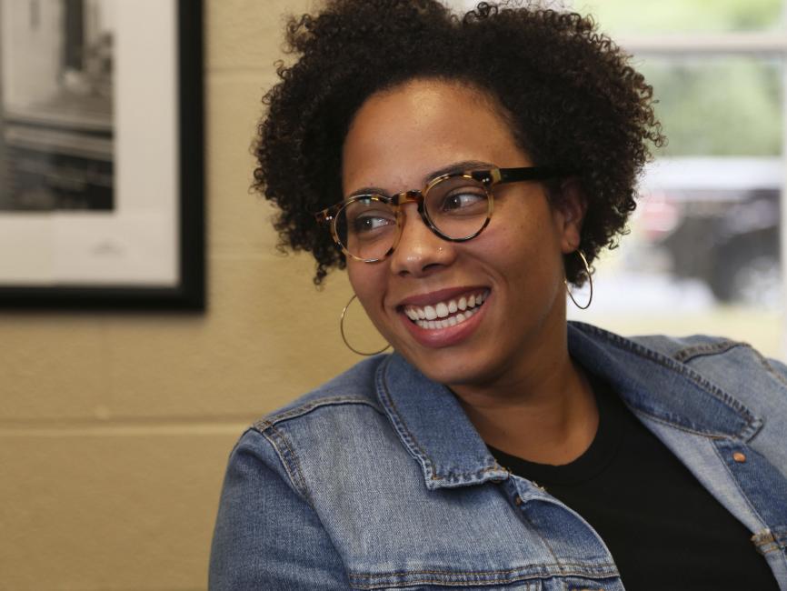 a young African American woman in tortoise shell glasses and hoop earrings