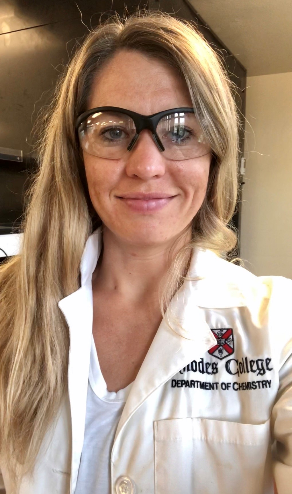 a woman with long blonde hair and safety glasses