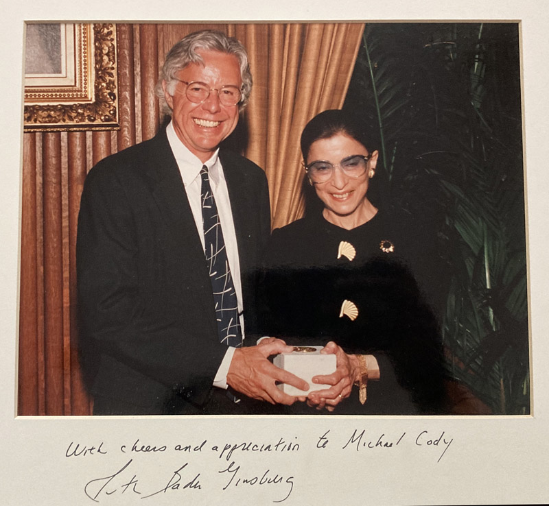 A man receives an award from a woman