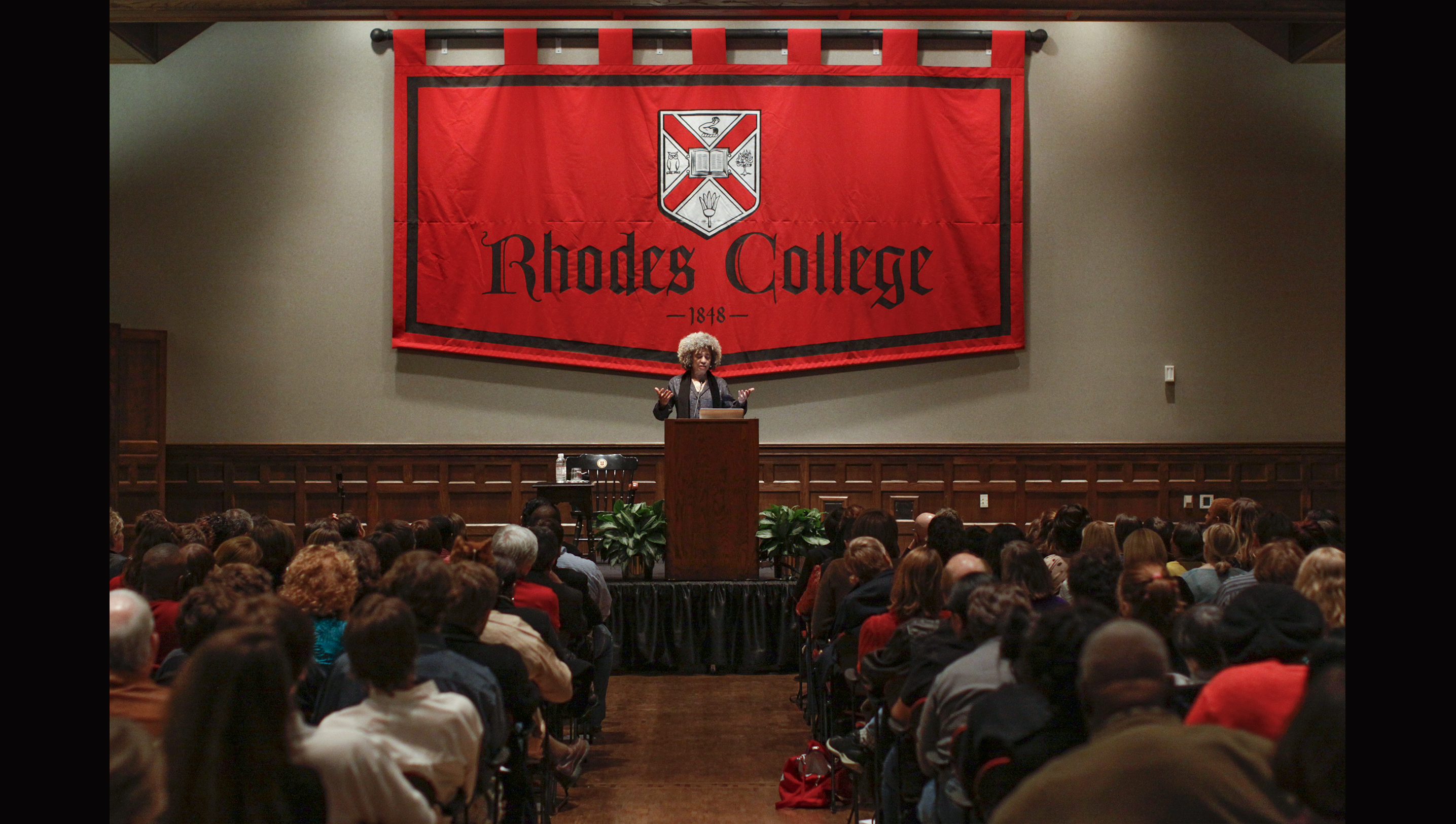 an African American woman speaks to a crowd