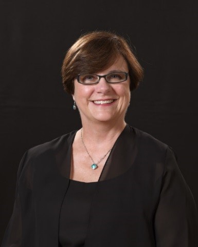 a woman with short hair and glasses