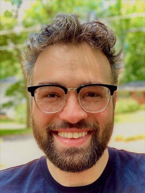 a man with a beard and glasses