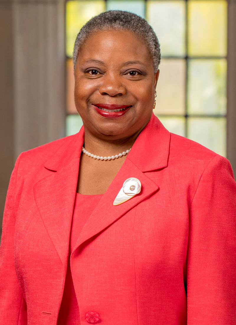 an African American woman in a red suit