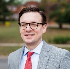 a man in a suit and glasses
