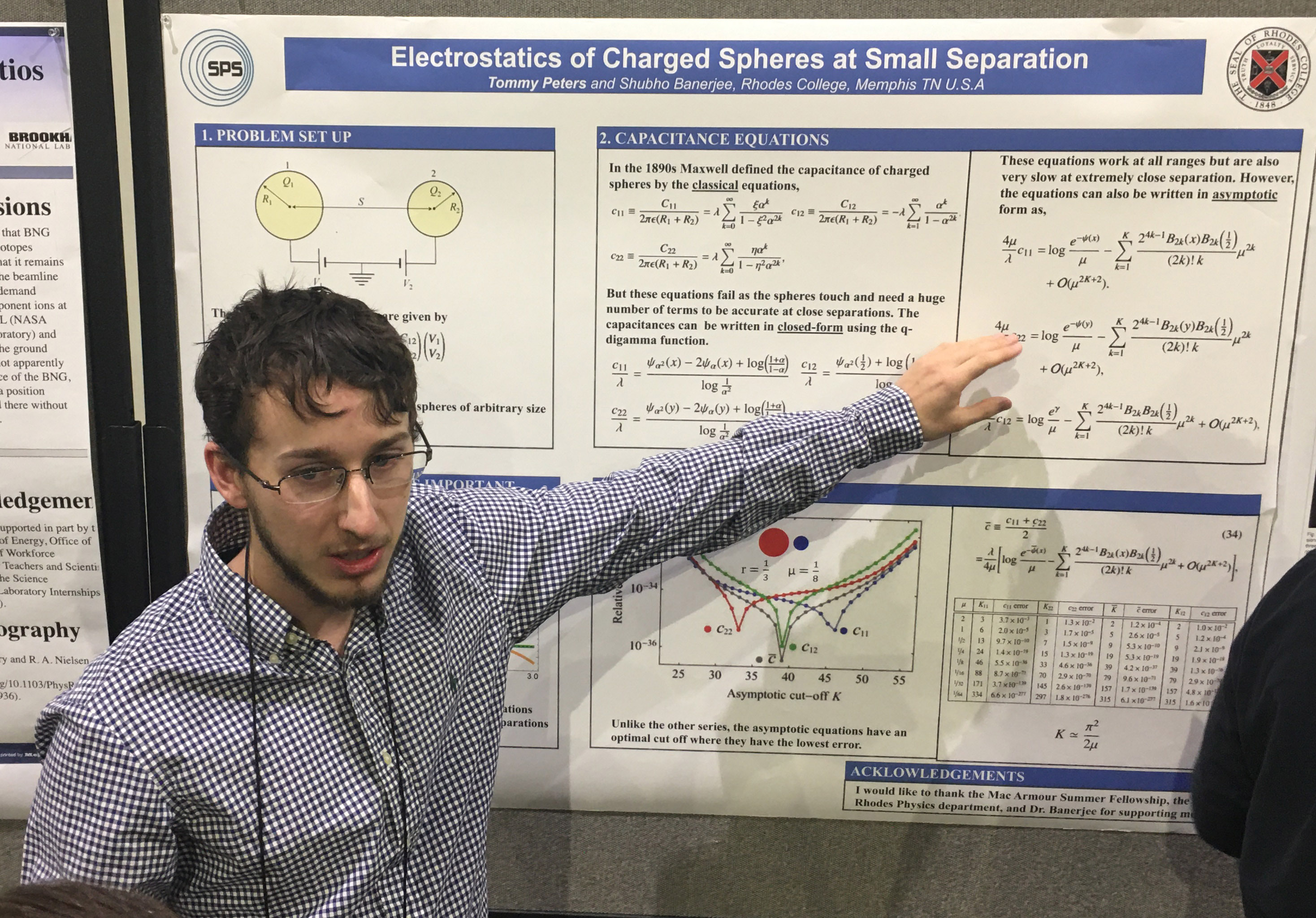 a male student presents a poster on physics