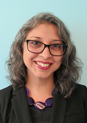 a woman with shoulder-length hair and glasses