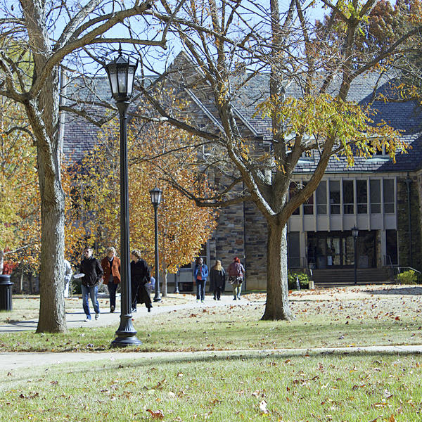 students walk on a campus in the fall