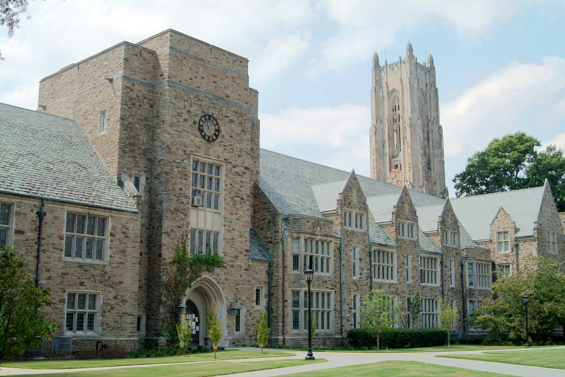 Southwestern Hall seen from the north with Halliburton Tower extending up toward a partly overcast sky.