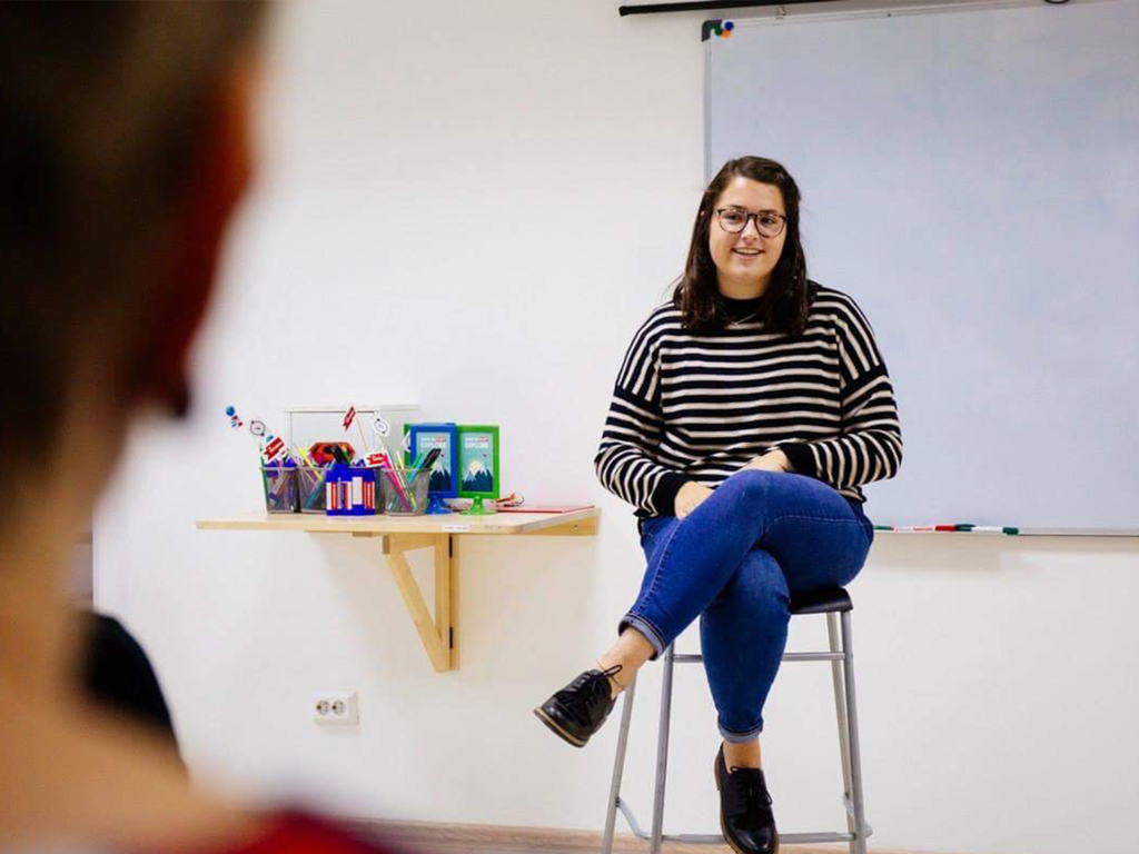 a young woman talks to a class