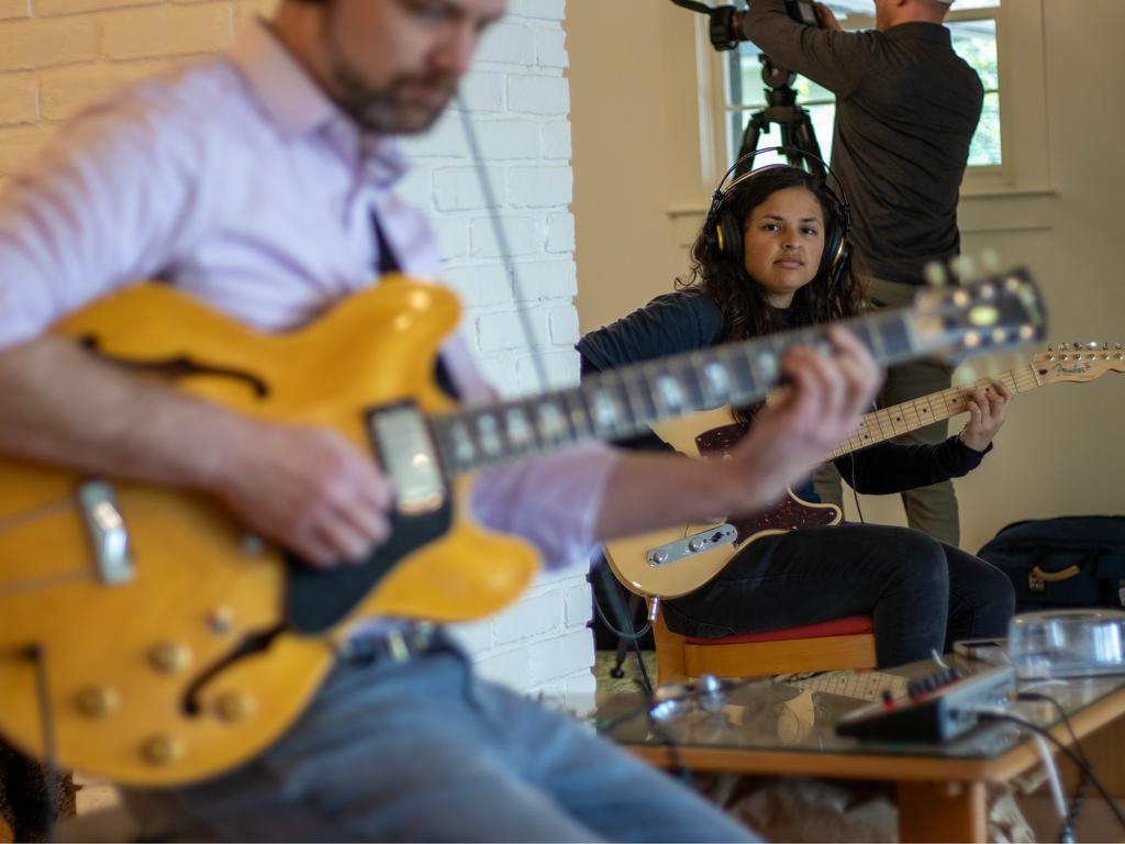 A student prepares to play along with award winning recording artists.