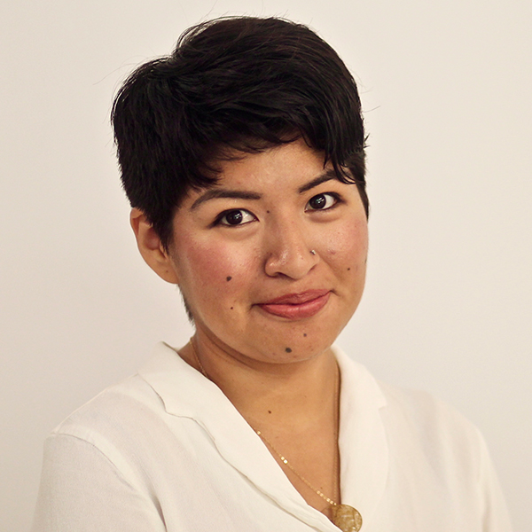 a young woman with short dark hair smiles at the camera