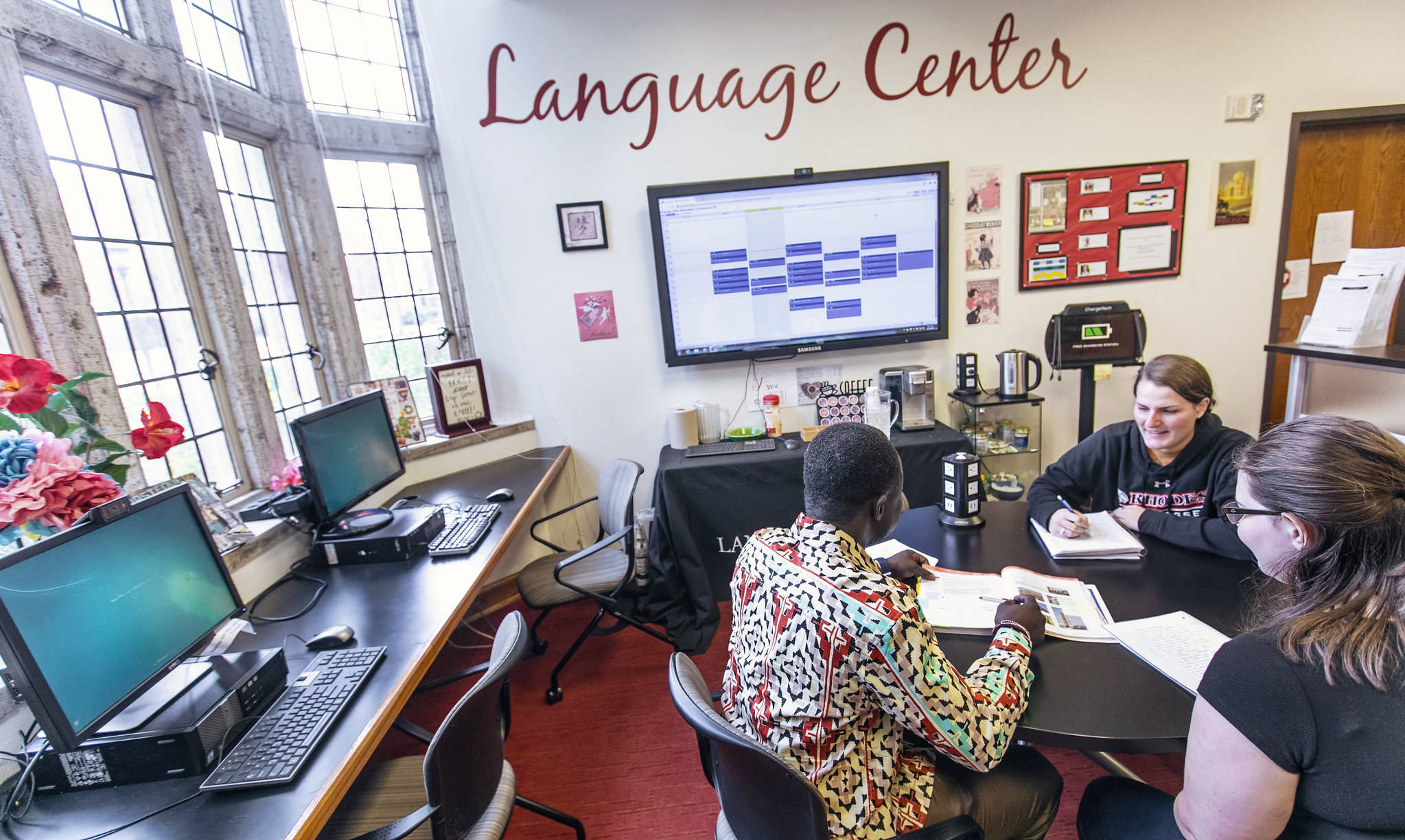 a professor and students study in the Language Center