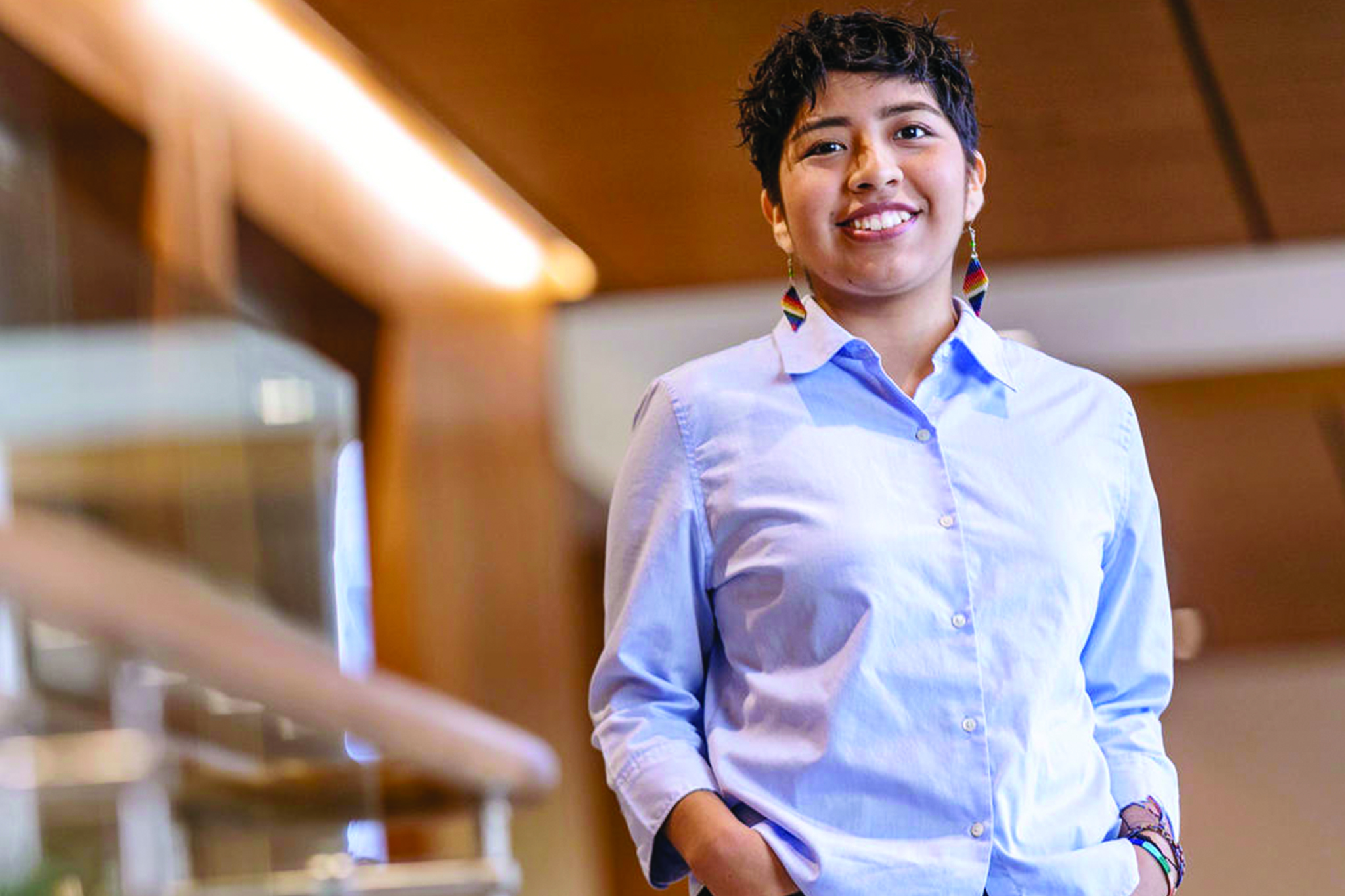 a young Latina woman smiles at the camera