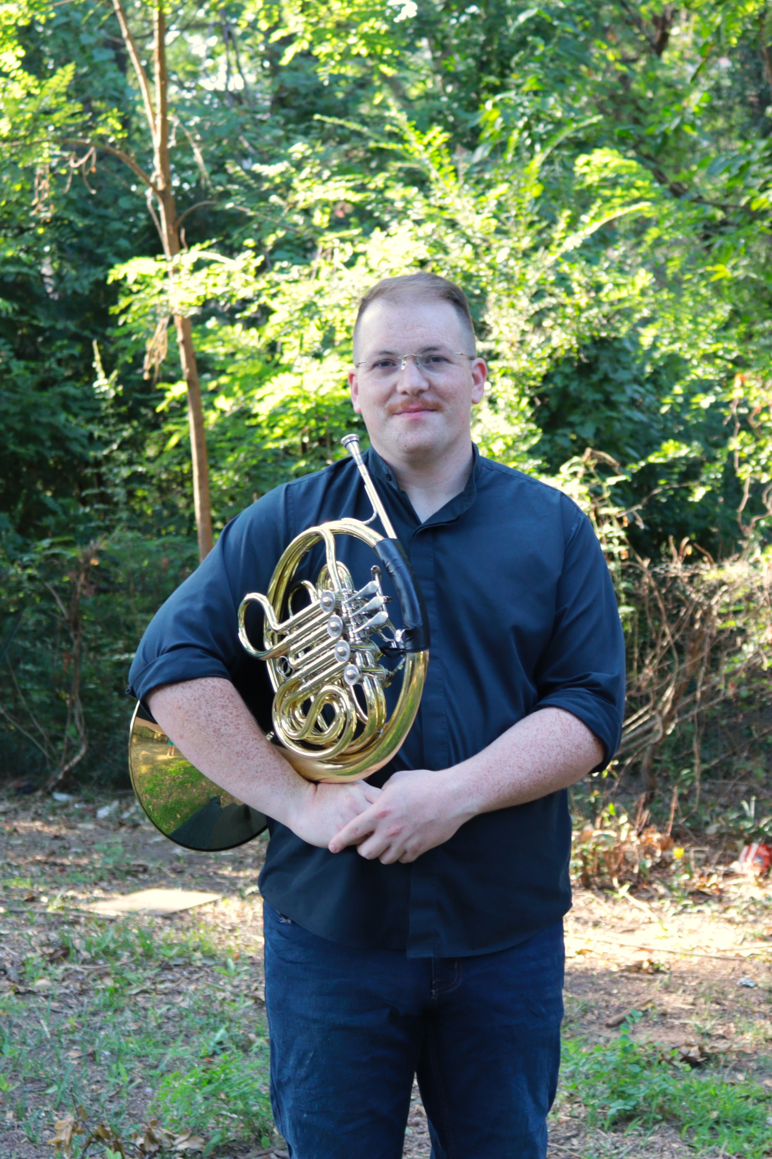 a man holding a horn