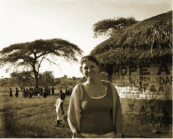 a woman outside a hut in Africa