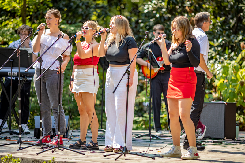 students sing on an outdoor stage