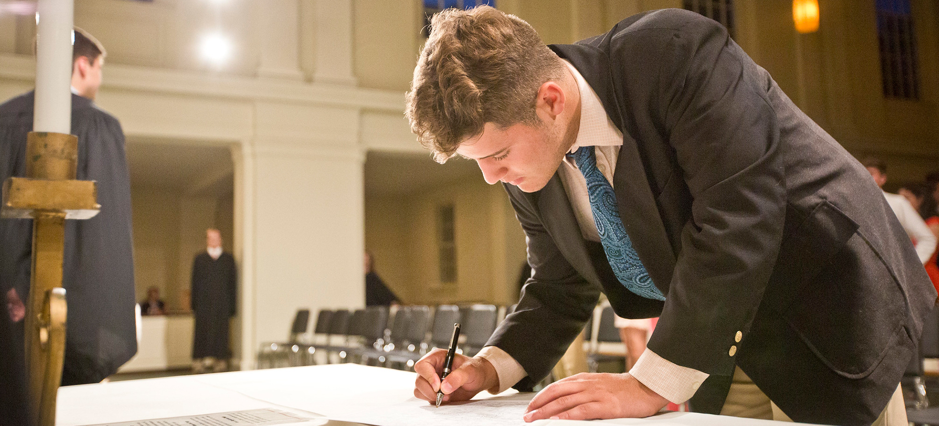 a young man signs a pledge