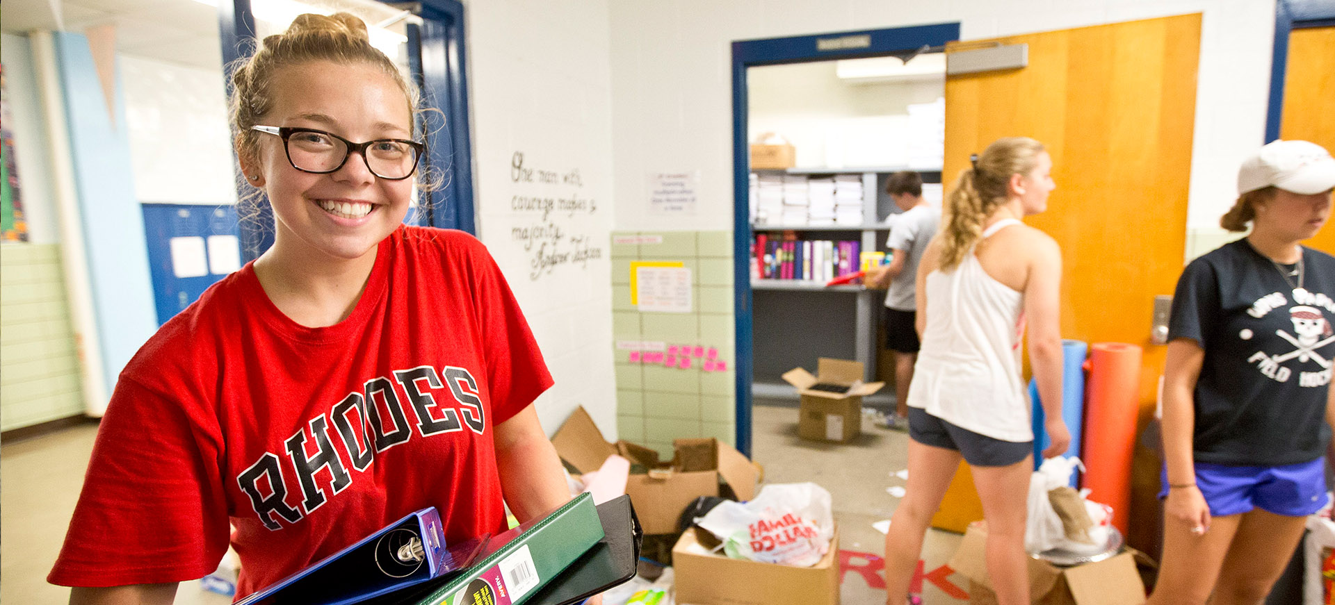 a young woman helps hand out supplies