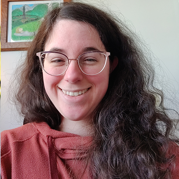 a young woman with curly hair and glasses