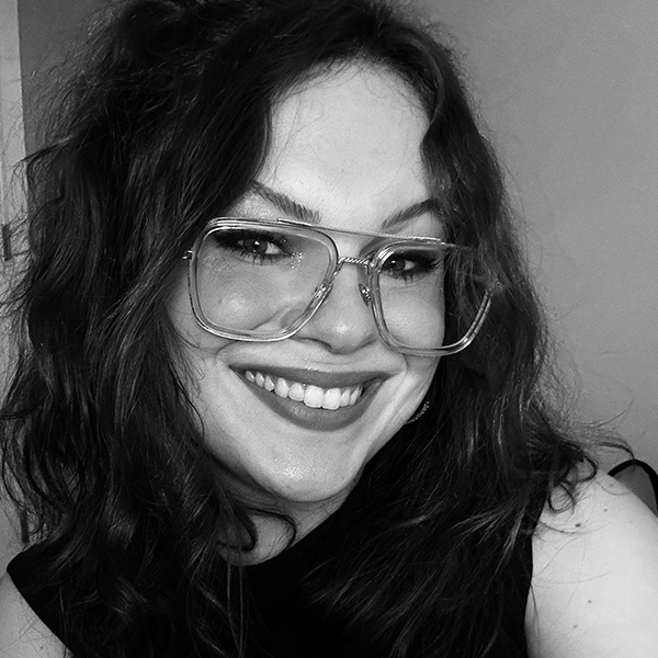 a black and white photo of a young woman with large glasses