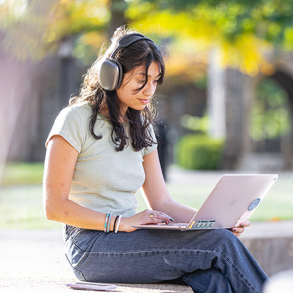 a young woman works on a laptop