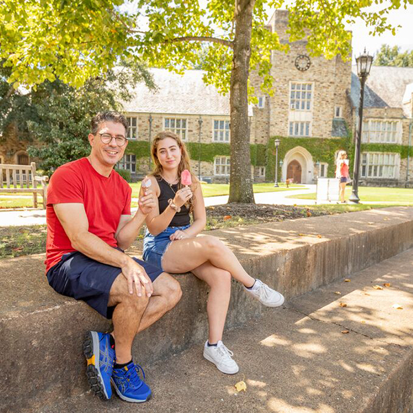 a father and daughter on a Gothic campus