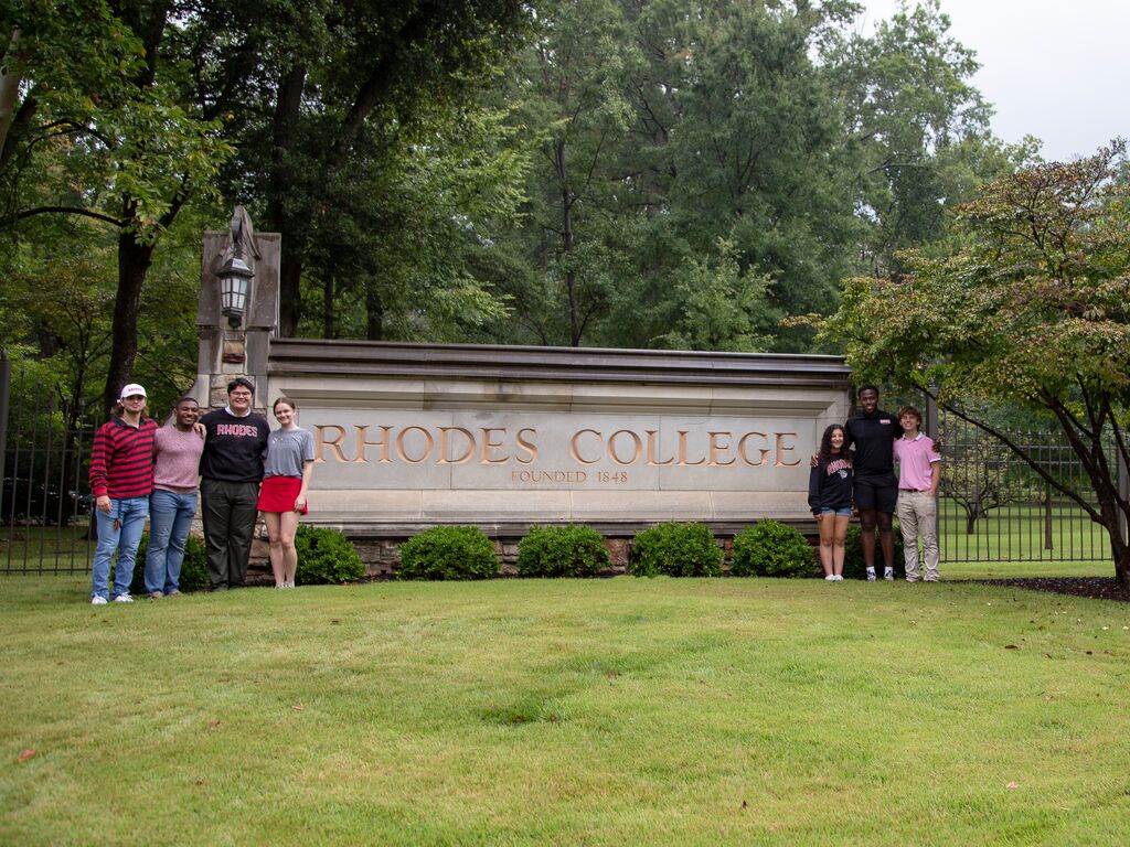 Students in front of Rhodes sign
